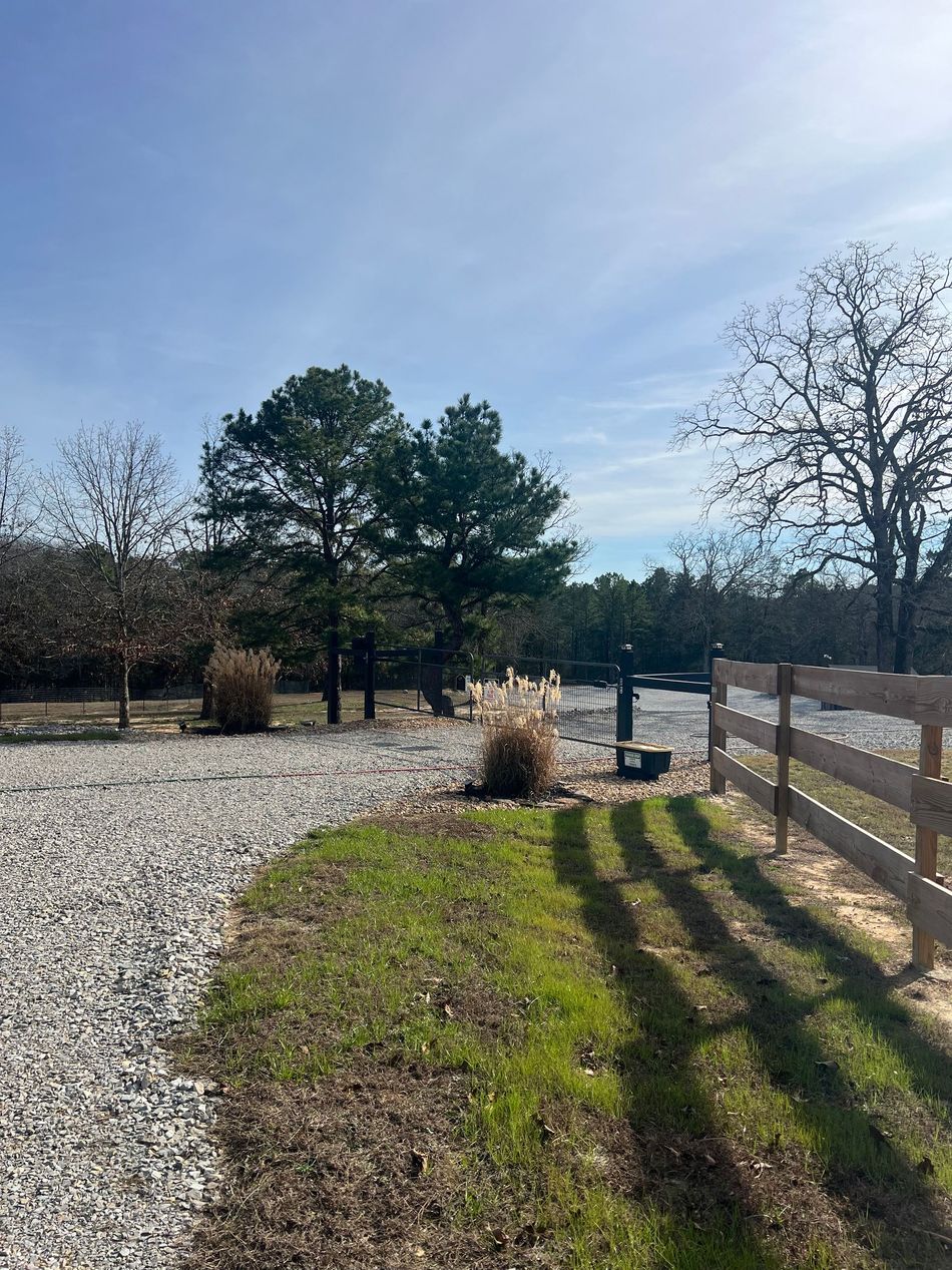 Tree-lined gravel drive inside White River Vacation RV Resort